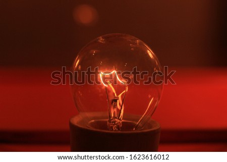 Light bulb on red background
