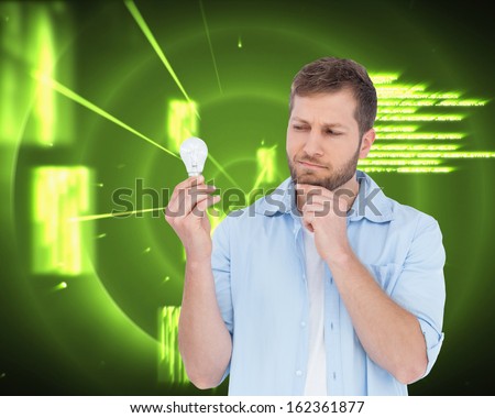 Composite image of skeptical model  holding a bulb 