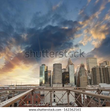 Buildings of lower Manhattan as seen from Brooklyn Bridge at sunset.