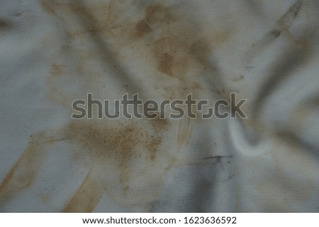 Close up brown stains on white fabrics.