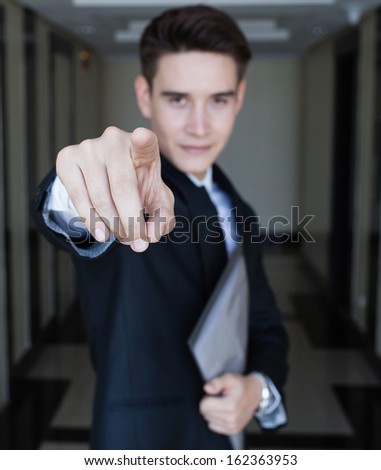 Handsome businessman pointing with his finger