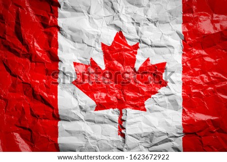 National flag of Canada on crumpled paper. Flag printed on a sheet. Flag image for design on flyers, advertising.