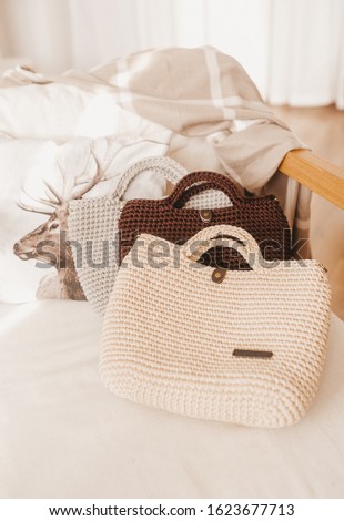 A collection of typical knitted ladies' bag on sofa. Closeup view.