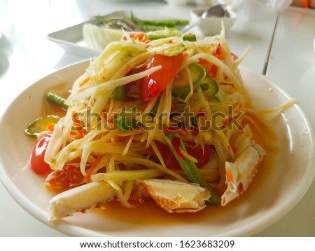 Spicy crab papaya salad, Thai food. Royalty-Free Stock Photo #1623683209