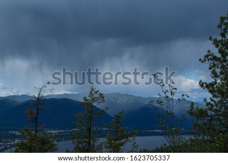 The rainy sky in the distance from a top a mountain 