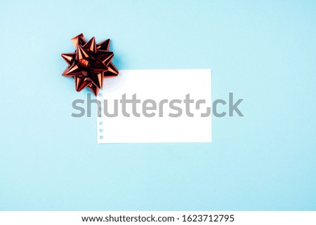 Blue background with gift bow and Notepad for Valentine's day. Space for text