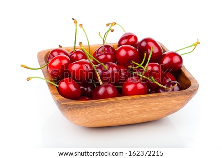 cherry berry in wooden bowl, isolated on white background