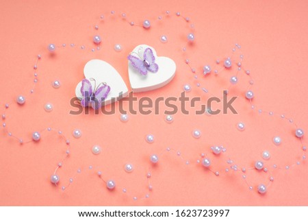 Valentine's Day . Blank for the designer. Valentines day concept. Greeting card. Copy spice. Two white wooden hearts on a pink background.