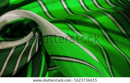 Texture,  silk fabric with a green striped pattern. The design of this fabric is devoted to a patchwork mosaic in the style of a white rabbit, representing what a fairytale's vest might look like.
