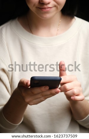 Close-up of a woman using mobile smart phone. Smartphone in female hands