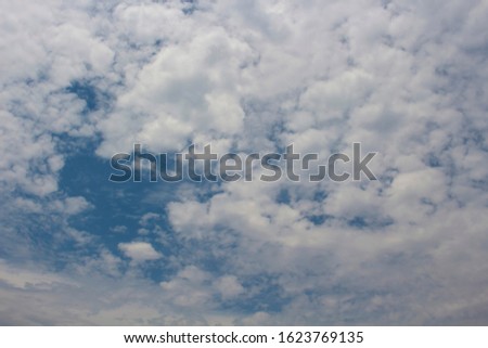 A stratocumulus cloud belongs to a genus-type of clouds characterized by large , rounded masses, usually in groups, lines, or waves, the individual elements being larger than those in altocumulus.
