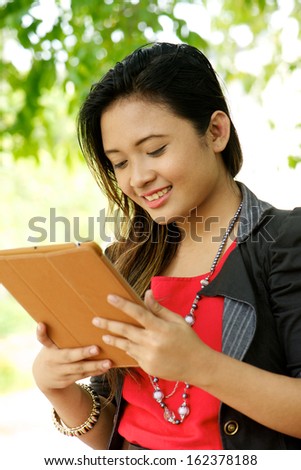 asian girl smile during use tablet