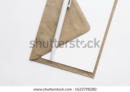 Empty envelope with blank paper and pen