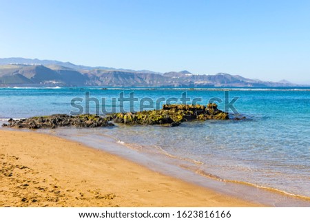 Las Canteras Beach (Playa de Las Canteras) in Las Palmas de Gran Canaria city, Canary island, Spain. Long beach with natural barrier reef in 200 metres from the shore, which protects it from the tides Royalty-Free Stock Photo #1623816166