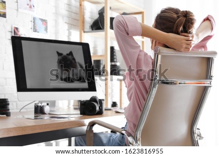 Professional photographer resting at table in office