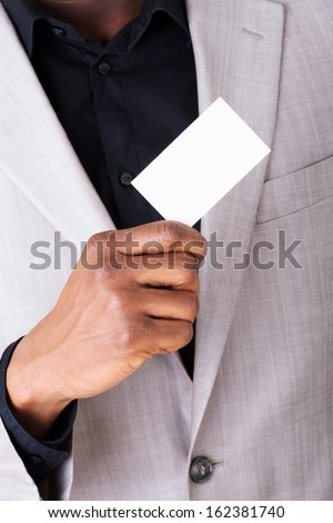 Male businessman holding a business card. Closeup. 