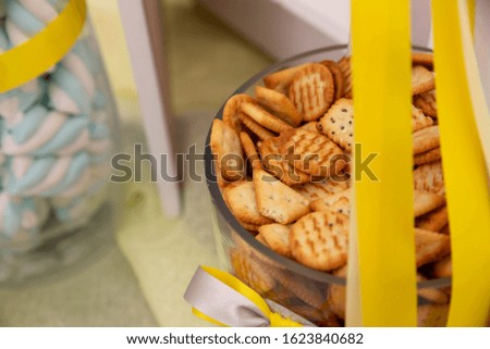A closeup of crackers in a bowl on the table with a blurred background