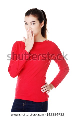 Attractive woman covering her mouth.  Isolated on white.