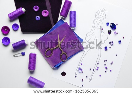 Set of tailor's supplies with sketch on white background