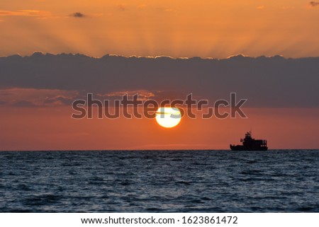 ray of light during full disk of sunset