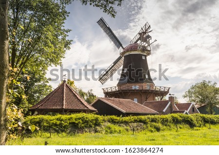 Windmill Rhaude in green nature in the county of Leer, East Frisia, Lower Saxony, Germany Royalty-Free Stock Photo #1623864274