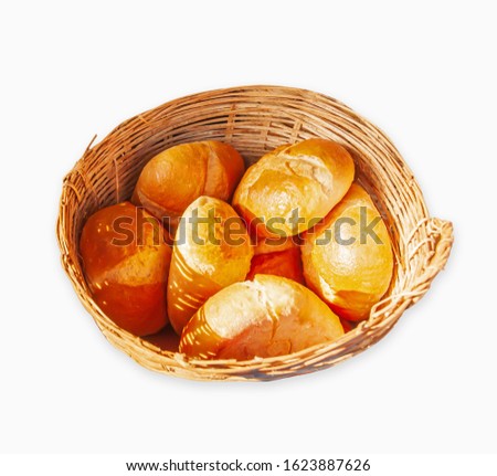 French Baguettes in a bamboo basket isolated on white background with clipping path. Fresh crispy Baguettes or French bread are sold in the wet market in Pakse, South Laos.