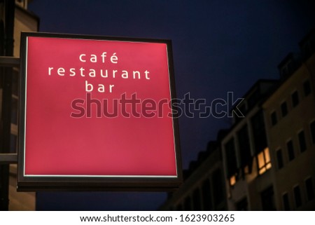 Cafe, restaurant, bar  neon red or pink sign. Bright sign at night. neon at night. Blank Lightbox Signage hang on wall. night city life.