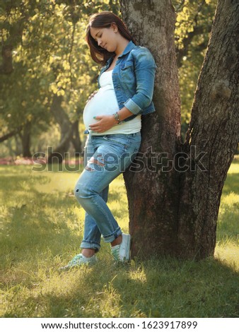 Photosession of pregnancy. Pregnant young girl. Photosession of pregnancy in nature. Royalty-Free Stock Photo #1623917899