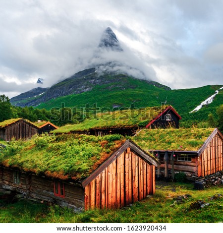 Typical norwegian old wooden houses with grass roofs in Innerdalen - Norway's most beautiful mountain valley, near Innerdalsvatna lake. Norway, Europe. Landscape photography