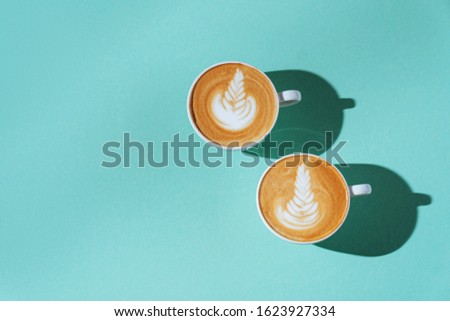 two Cup of coffee cappuccino on color background