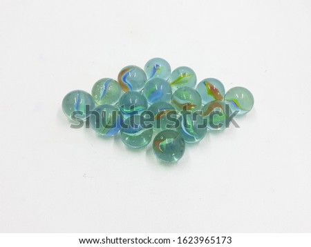 Colorful Transparent Glass Plastic Marbles for Kids Playground Games in White Isolated background