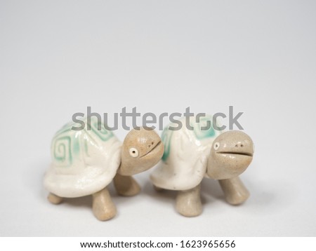 Cute turtle figurines. White background.