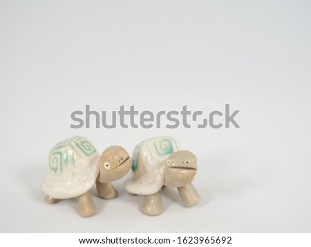 Cute turtle figurines. White background.