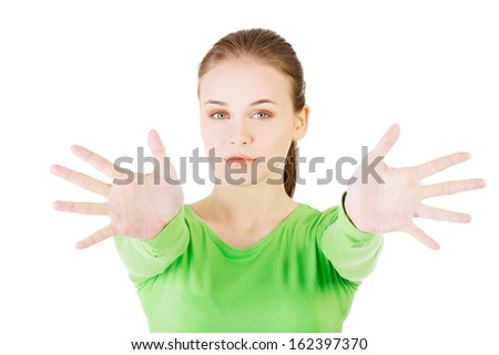 Attractive  woman with hands open in front oh her. Isolated on white. 