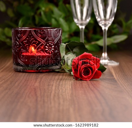 Red rose with candle on a wooden background stock images. Romantic still life with red rose and glasses of champagne. Valentines Day concept. Valentines Day backgound with copy space for text