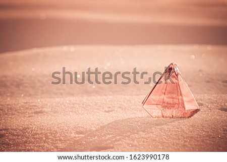Abstract background with a glass prism in the snow. Abstraction. Post apocalypse.