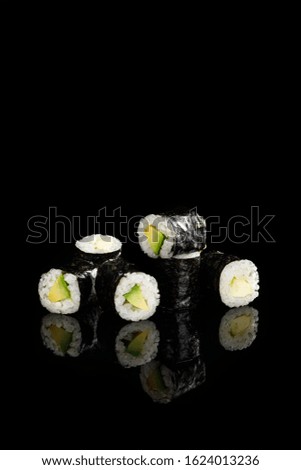 delicious sushi maki with avocado isolated on black