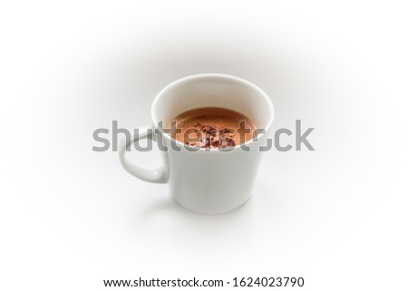 Photograph of a white cup of coffee with cinnamon to wake up in the morning and start the day well