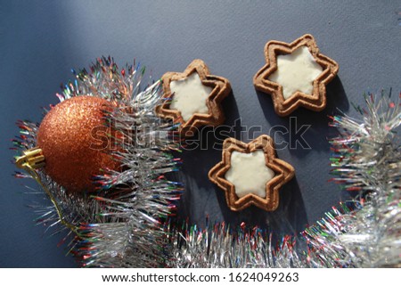 Christmas decorative rain, star cookies Christmas tree toy on a blue background.