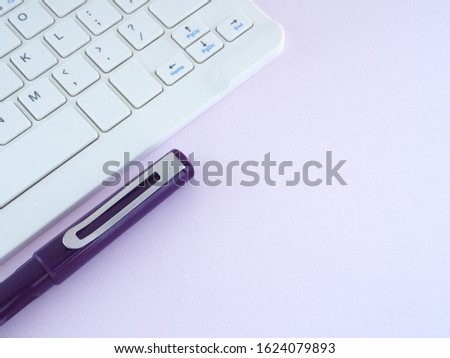 Pen and Keyboard on white office desktop with copy space.