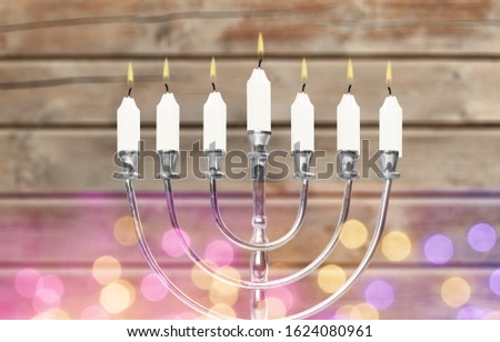 Religion jewish holiday Hanukkah with menorah, candelabra and oil candles