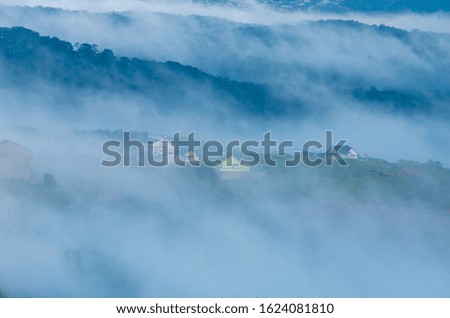 the fog cover houses in valley with magical of the sky and light at sunrise, best photo use for idea printing, design travel and more