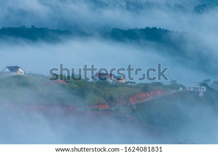 the fog cover houses in valley with magical of the sky and light at sunrise, best photo use for idea printing, design travel and more