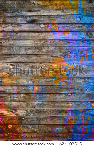 Spots of multi-colored paint on a wooden wall. Spots of multi-colored paint on a wooden wall. Abstract background for business cards and covers. 