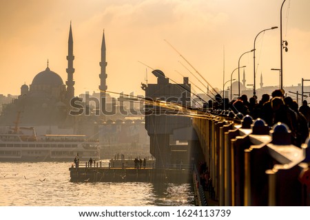 Istanbul, people fishing at sunset on Galata Bridge - Turkey Royalty-Free Stock Photo #1624113739