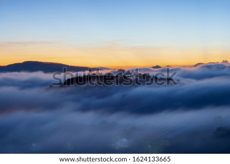 beauty landscape with fresh fog and magical of the sky and clouds cover houses in valley at sunrise, photo use for idea printing, travel design and more