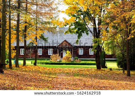 Old traditional polish wooden house in an open-air museum of Kielce (Muzeum Wsi Kieleckiej), Tokarnia, Poland, Europe. Picture taken during famous polish golden autumn.