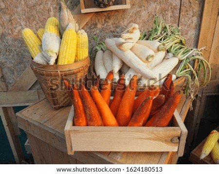 Yellow corn,white radish,carrot in a wooden basket for cooking