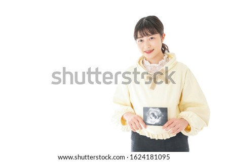 Young pregnant woman having her photo