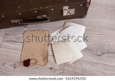 Vintage luggage with blank space of photo frame on wooden table. Journey memory concept. Top view